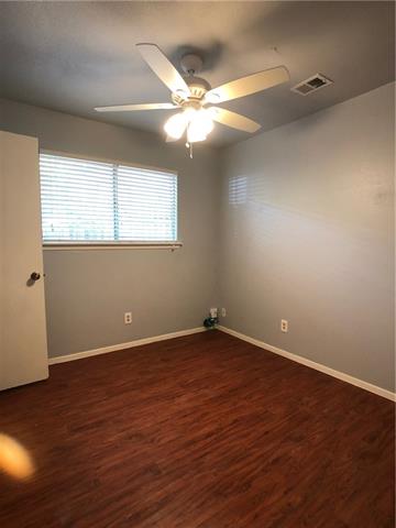 4008 Cima Serena Drive, Unit B Austin, TX 78759 - Photo 11 of 16 an empty room with wooden floor and windows
