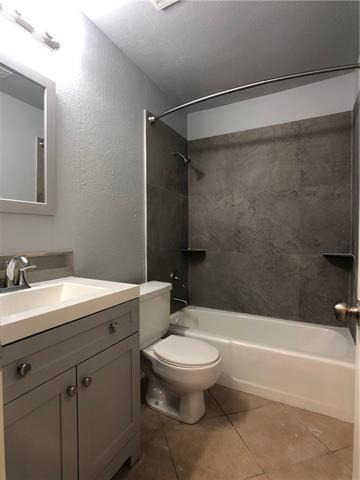 4008 Cima Serena Drive, Unit B Austin, TX 78759 - Photo 13 of 16 a bathroom with a sink a toilet and a bathtub