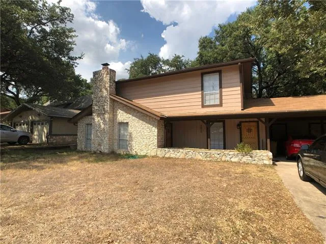 a view of an empty room with a fireplace and a window