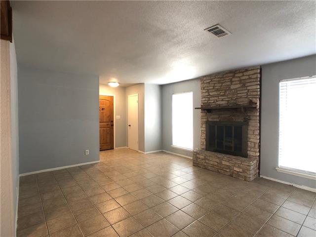 4008 Cima Serena Drive, Unit B Austin, TX 78759 - Photo 4 of 16 a view of an empty room with a fireplace and a window