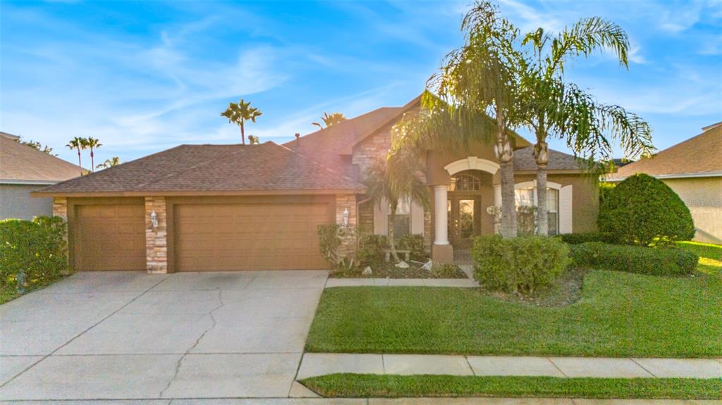 a front view of a house with a yard and garage