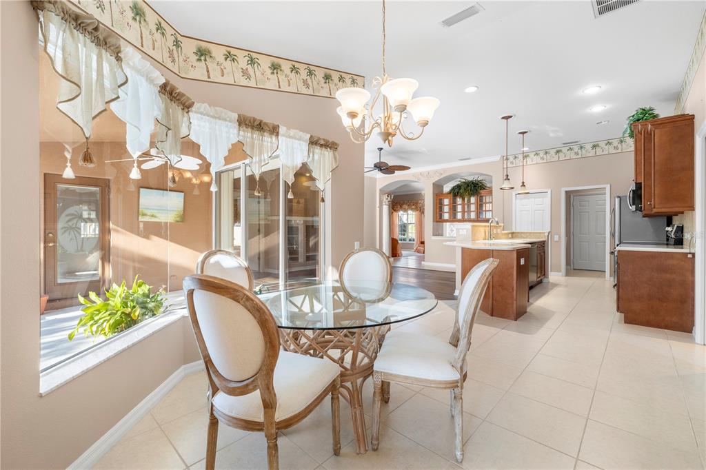 2125 Gold Dust Court New Port Richey, FL 34655 - Photo 25 of 54 a view of a dining room with furniture and a chandelier