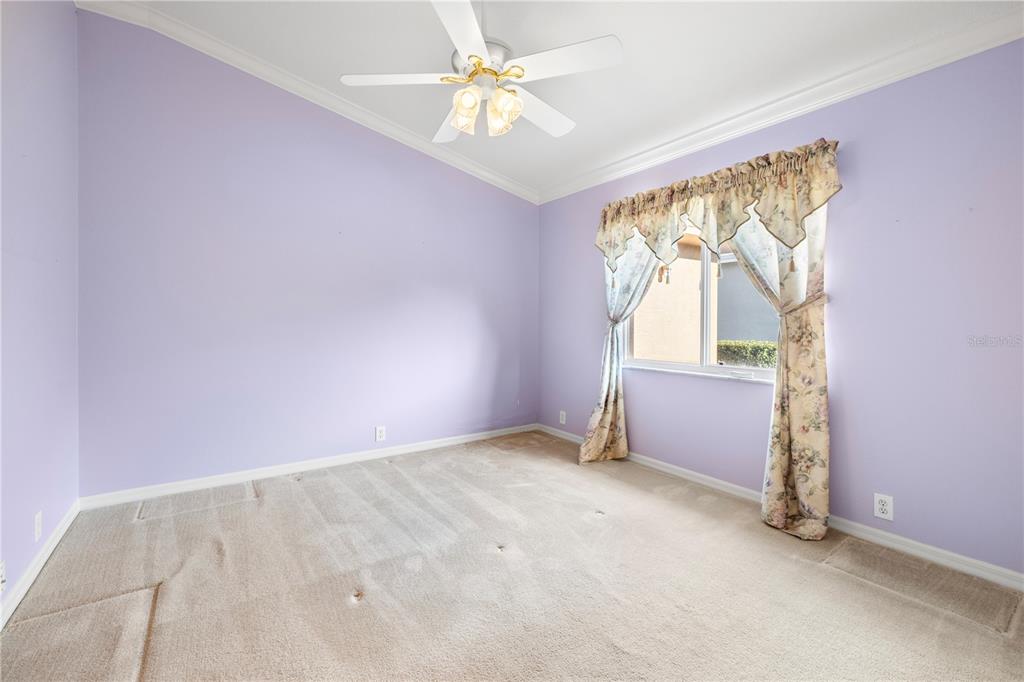 2125 Gold Dust Court New Port Richey, FL 34655 - Photo 27 of 54 an empty room with windows and fan
