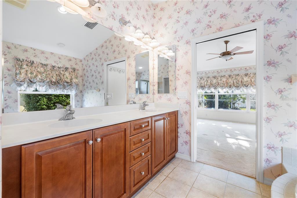 2125 Gold Dust Court New Port Richey, FL 34655 - Photo 40 of 54 a spacious bathroom with a double vanity sink and a large mirror