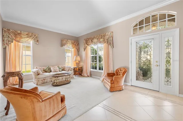 a living room with furniture and large windows