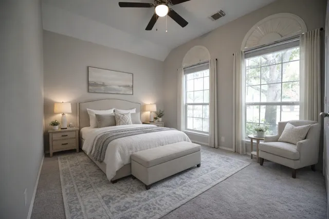 a spacious bedroom with a bed and a couch