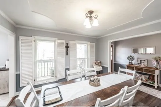 a room with stainless steel appliances kitchen island granite countertop a sink cabinets and wooden floor