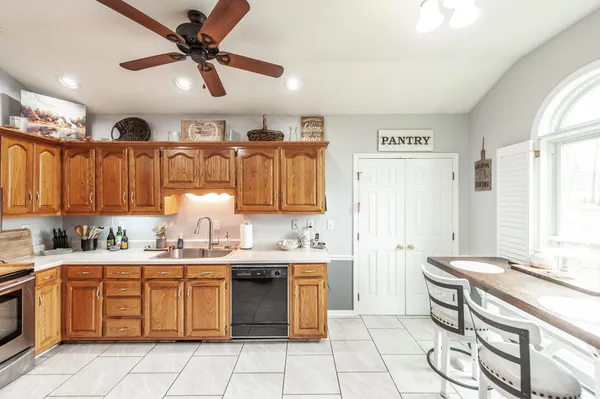 a kitchen with stainless steel appliances a refrigerator sink and cabinets
