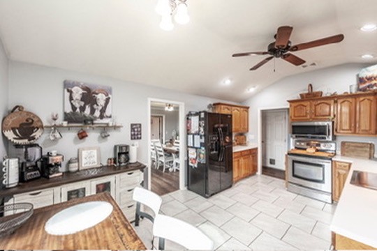 1251 Smith Thompson Road Bethpage, TN 37022 - Photo 19 of 71 a room with stainless steel appliances kitchen island granite countertop a sink cabinets and wooden floor