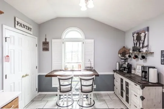 a living room with furniture fireplace and a large window