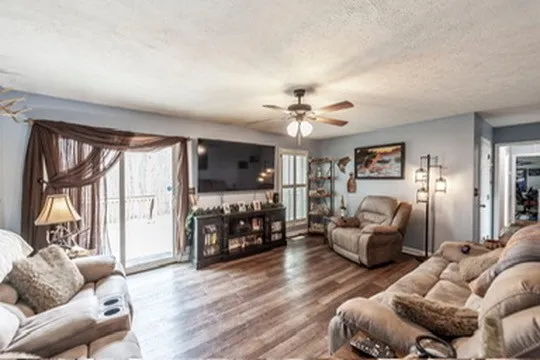 a bedroom with furniture and a flat screen tv