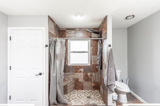 1251 Smith Thompson Road Bethpage, TN 37022 - Photo 32 of 71 a bathroom with a granite countertop shower a toilet and a sink