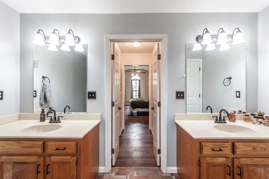 a view of a hallway with wooden floor and stairs