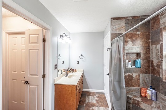 1251 Smith Thompson Road Bethpage, TN 37022 - Photo 37 of 71 a bathroom with a granite countertop sink a mirror and shower