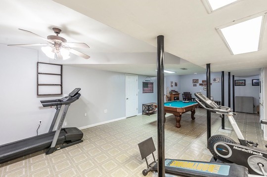1251 Smith Thompson Road Bethpage, TN 37022 - Photo 48 of 71 a room with gym equipment and a chandelier