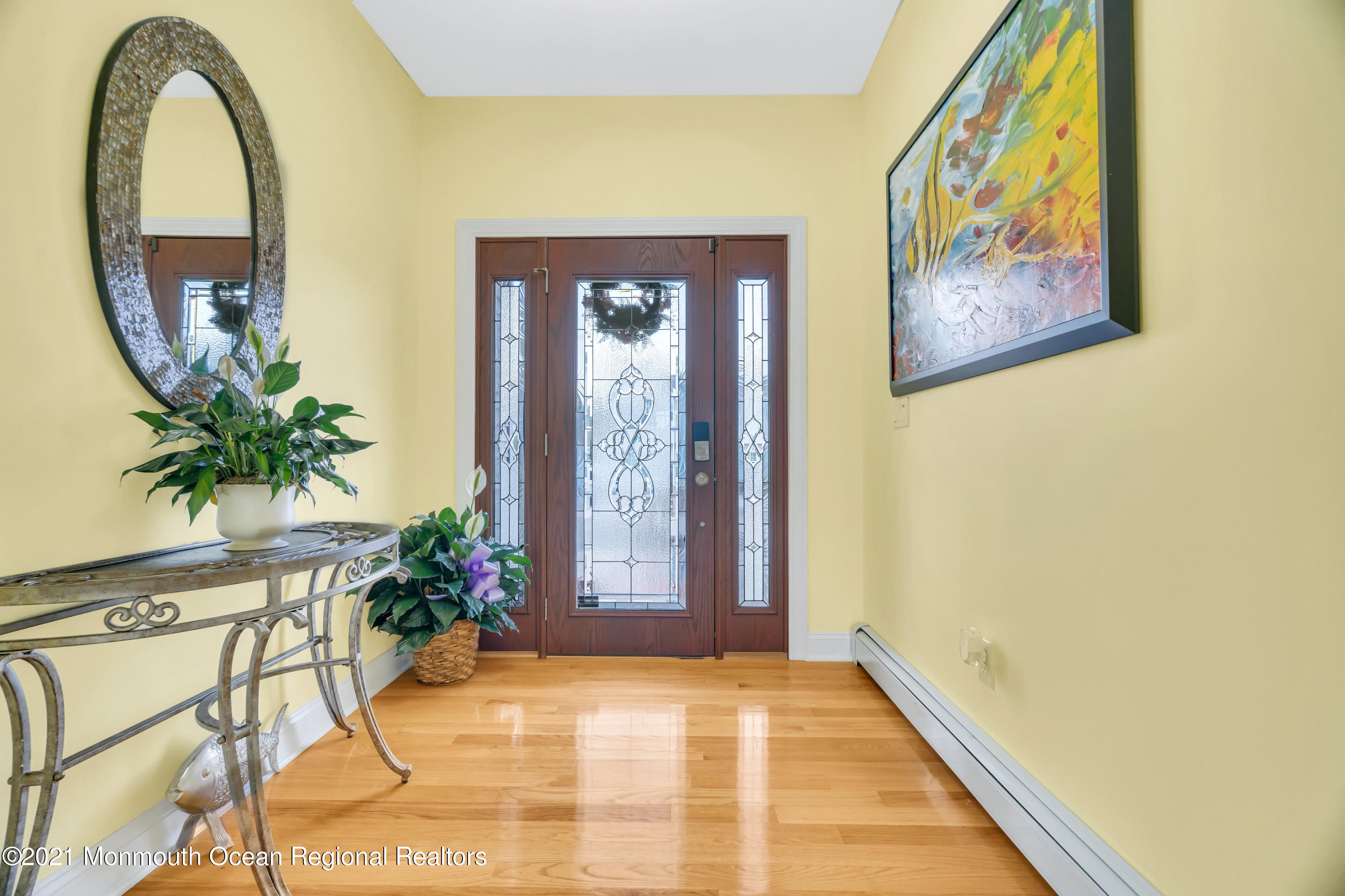 a view of entryway with paintings on the wall