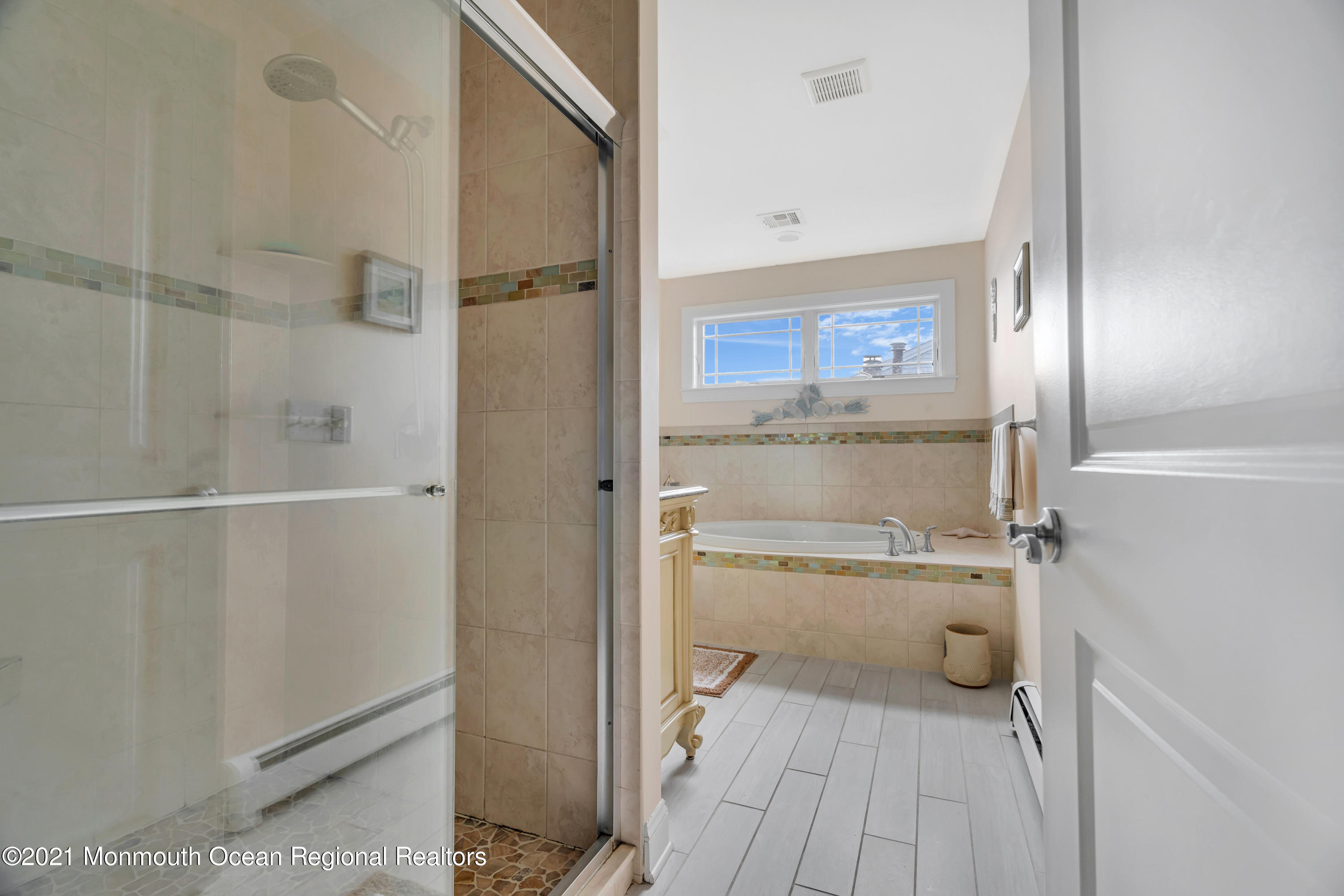 55 Bay Way Brick, NJ 08723 - Photo 29 of 55 a bathroom with a sink and a glass door shower