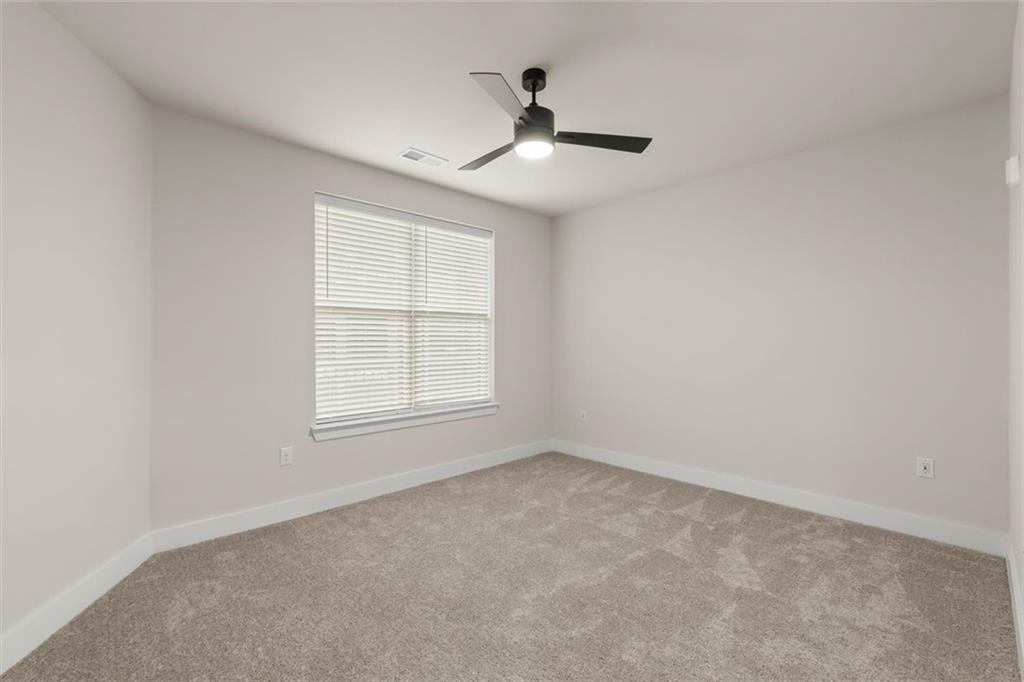 2648 Sandy Plains Road, Unit 422 Marietta, GA 30066 - Photo 17 of 37 an empty room with a window and a ceiling fan