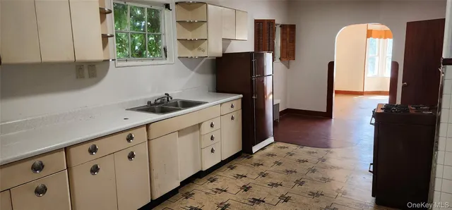 a kitchen with stainless steel appliances a refrigerator sink and cabinets