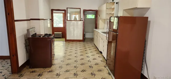 a view of a refrigerator and an entryway