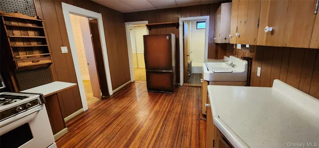 a view of a kitchen from a hallway