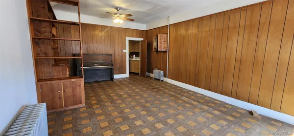 a view of kitchen with stainless steel appliances wooden floor and staircase