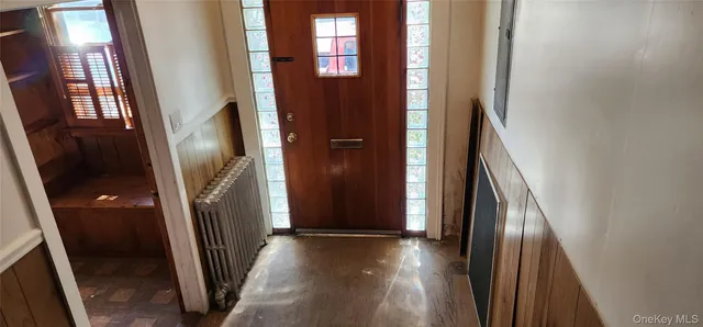 a view of a hallway with wooden floor and stairs