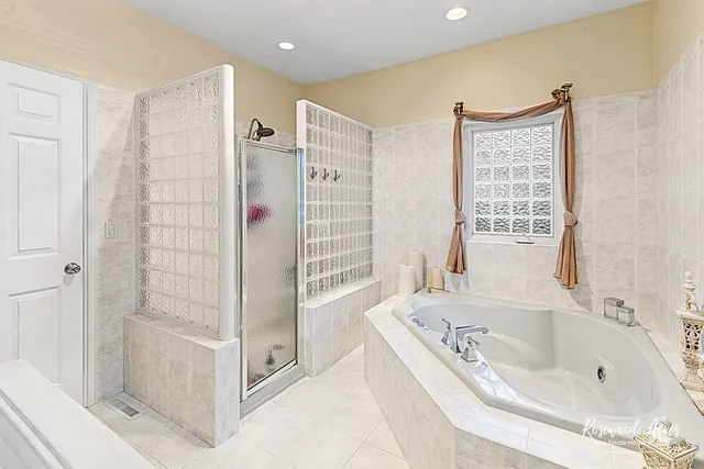 a bathroom with a bathtub and a shower