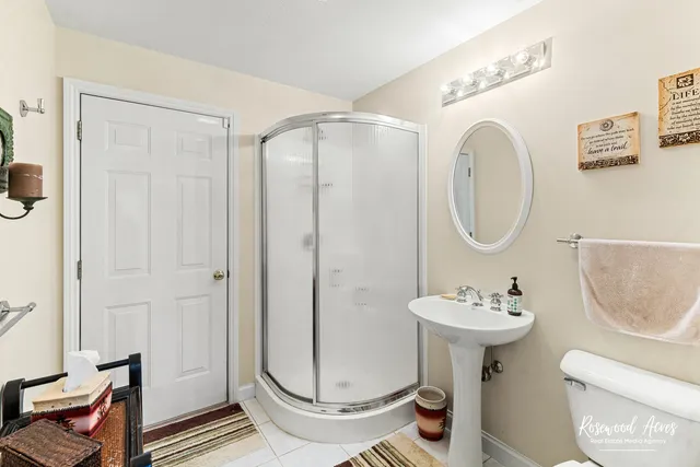 a bathroom with a sink toilet and a mirror