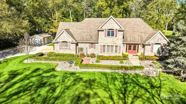 a view of a house with a big yard potted plants and large tree