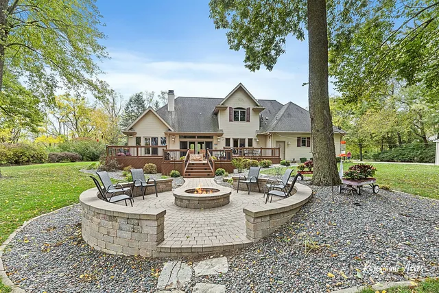 a view of a house with backyard sitting area and garden
