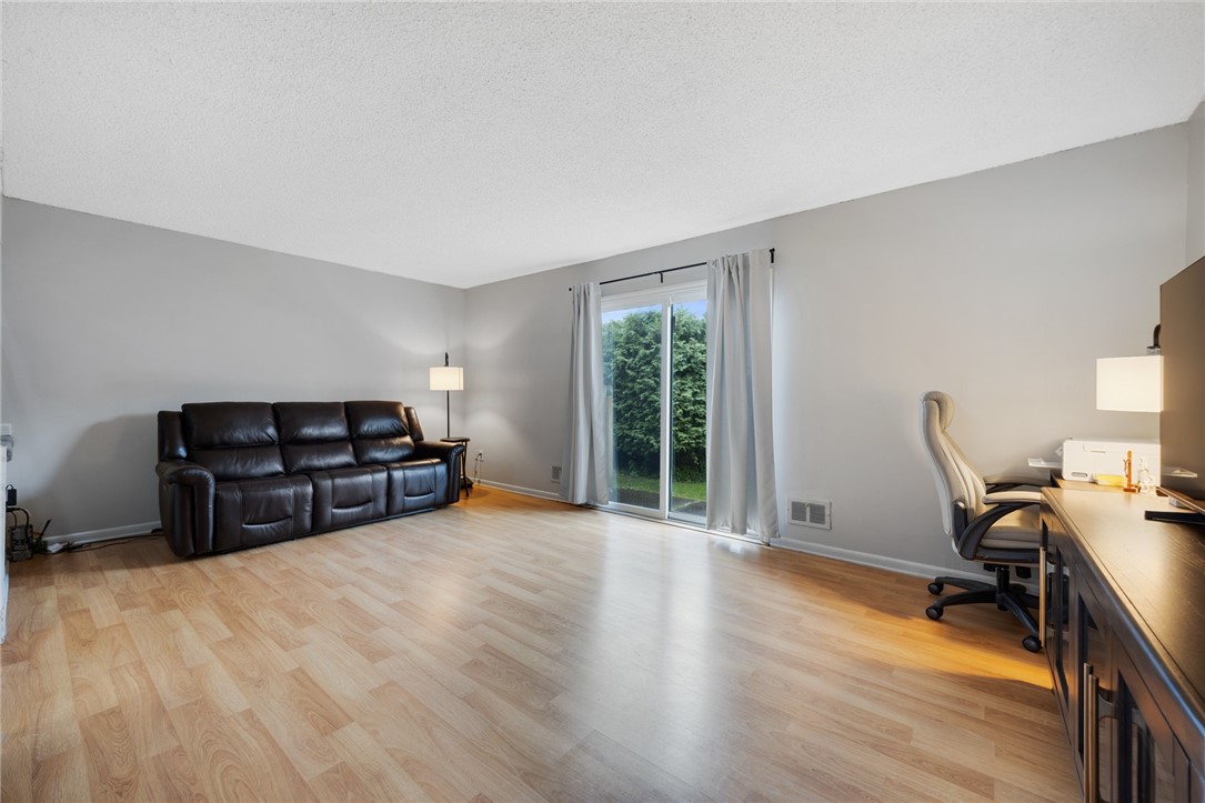 597 French Road Brighton, NY 14618 - Photo 8 of 24 Living room with sliding glass door to the patio.