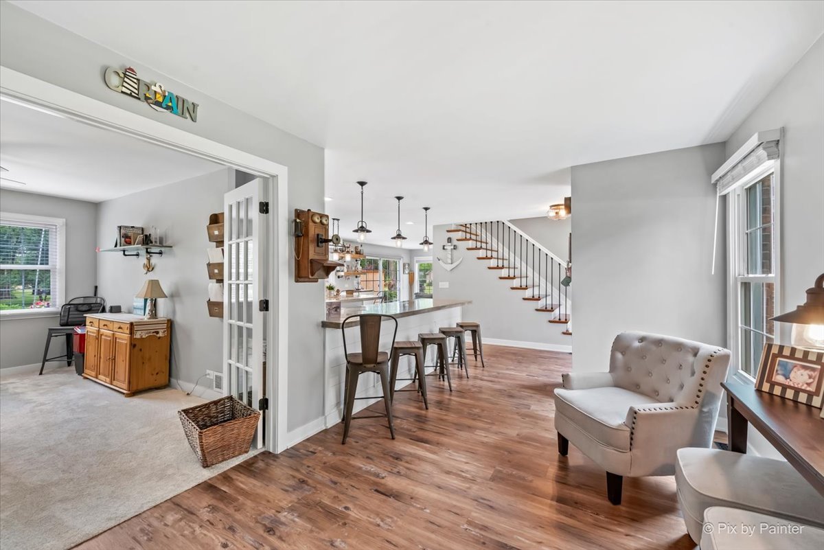 3205 Ramsgate Lane Johnsburg, IL 60051 - Photo 12 of 41 a living room with furniture and a wooden floor