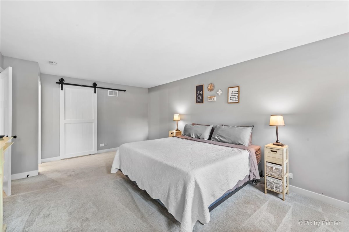 3205 Ramsgate Lane Johnsburg, IL 60051 - Photo 17 of 41 a bedroom with a bed and a view of bathroom