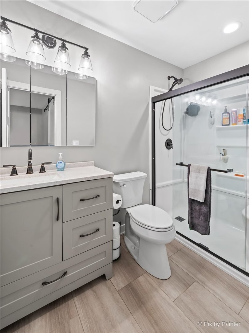 3205 Ramsgate Lane Johnsburg, IL 60051 - Photo 18 of 41 a bathroom with a toilet sink and shower