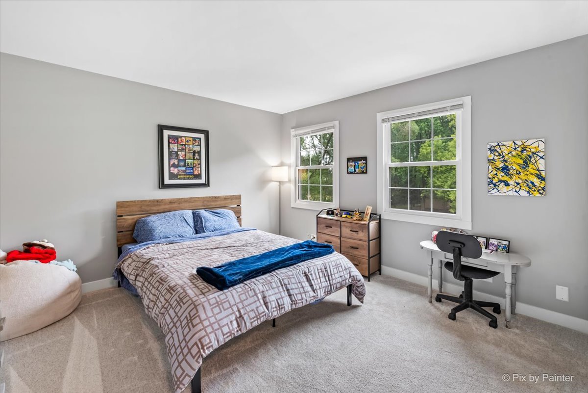 3205 Ramsgate Lane Johnsburg, IL 60051 - Photo 20 of 41 a bedroom with a bed a baby desk and chair next to a window