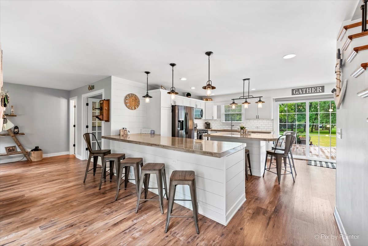 3205 Ramsgate Lane Johnsburg, IL 60051 - Photo 3 of 41 a large white kitchen with lots of furniture and appliances