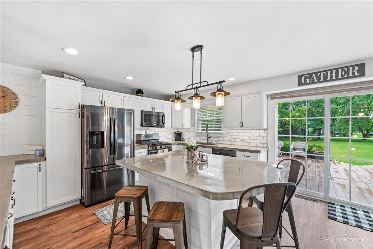 3205 Ramsgate Lane Johnsburg, IL 60051 - Photo 4 of 41 a dining room with stainless steel appliances a dining table and chairs