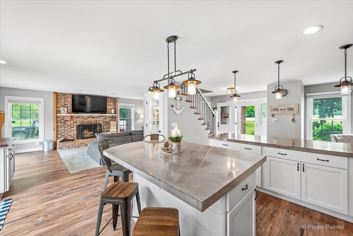 3205 Ramsgate Lane Johnsburg, IL 60051 - Photo 6 of 41 a kitchen with a table chairs sink and wooden floor