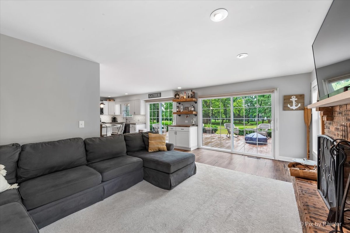 3205 Ramsgate Lane Johnsburg, IL 60051 - Photo 10 of 41 a living room with fireplace furniture and a large window
