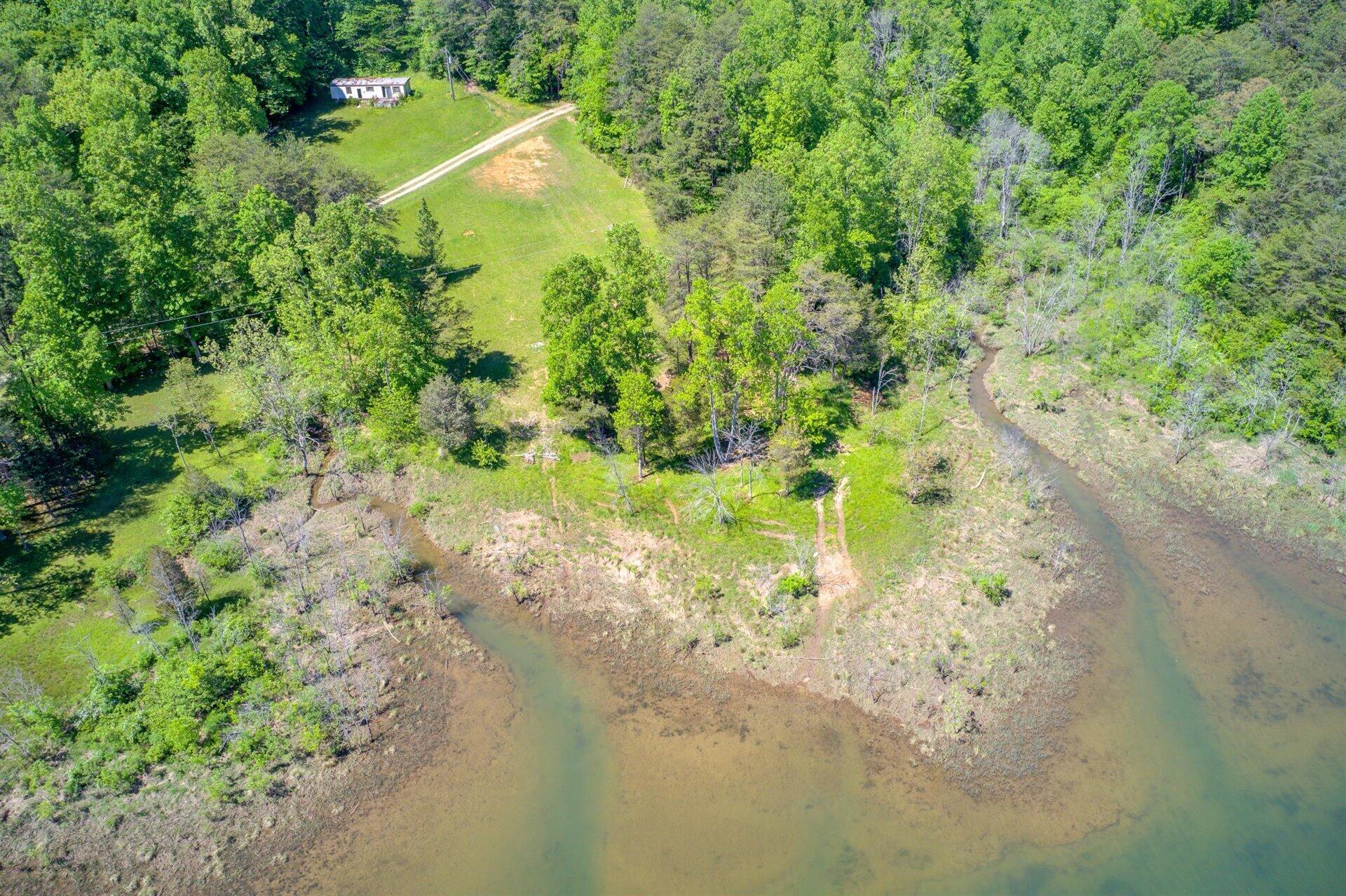 615 Faith Cove Road Sandy Level, VA 24161 - Photo 41 of 49 a view of a lake with a yard