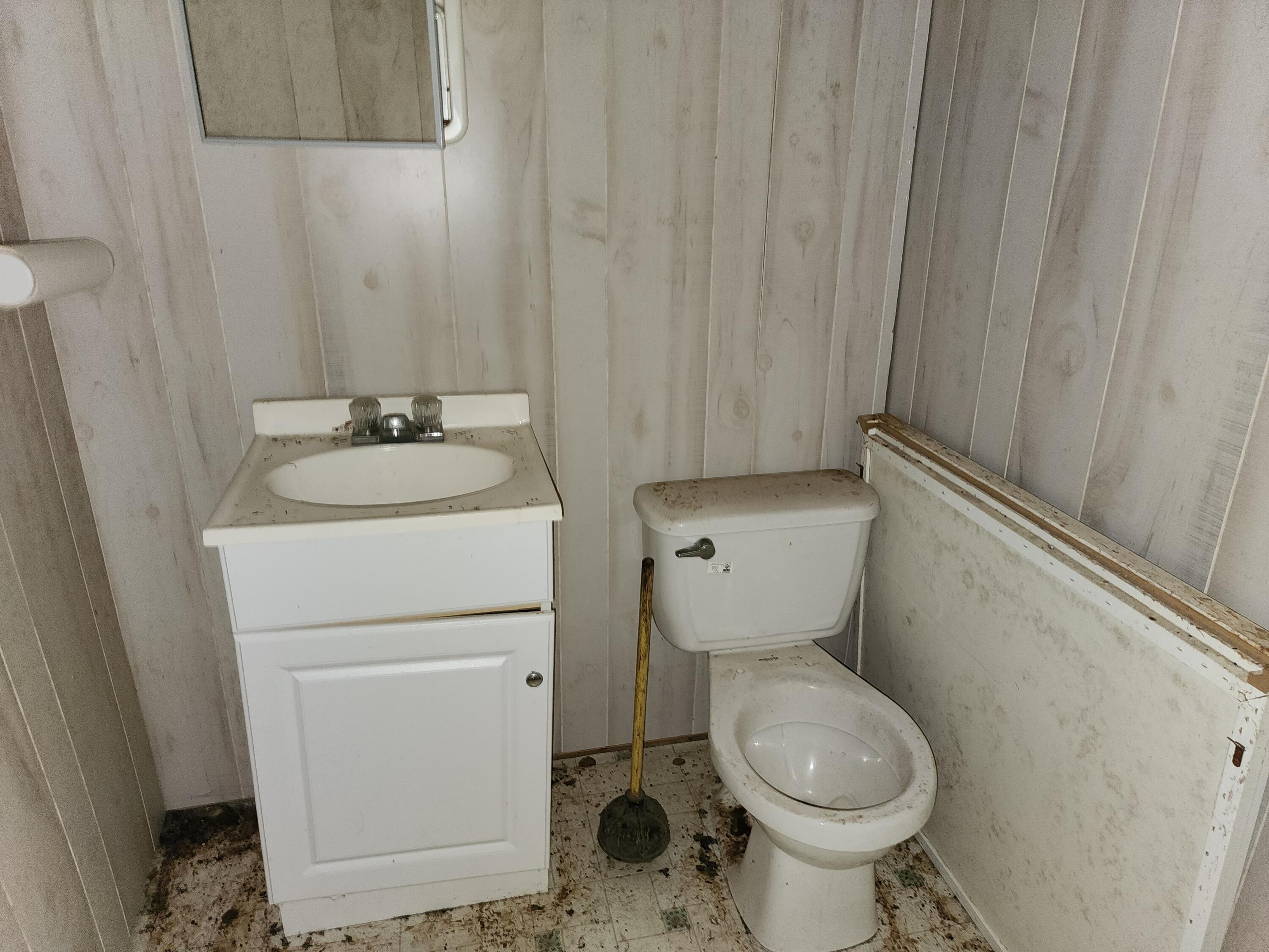 615 Faith Cove Road Sandy Level, VA 24161 - Photo 6 of 49 a bathroom with a toilet sink and mirror