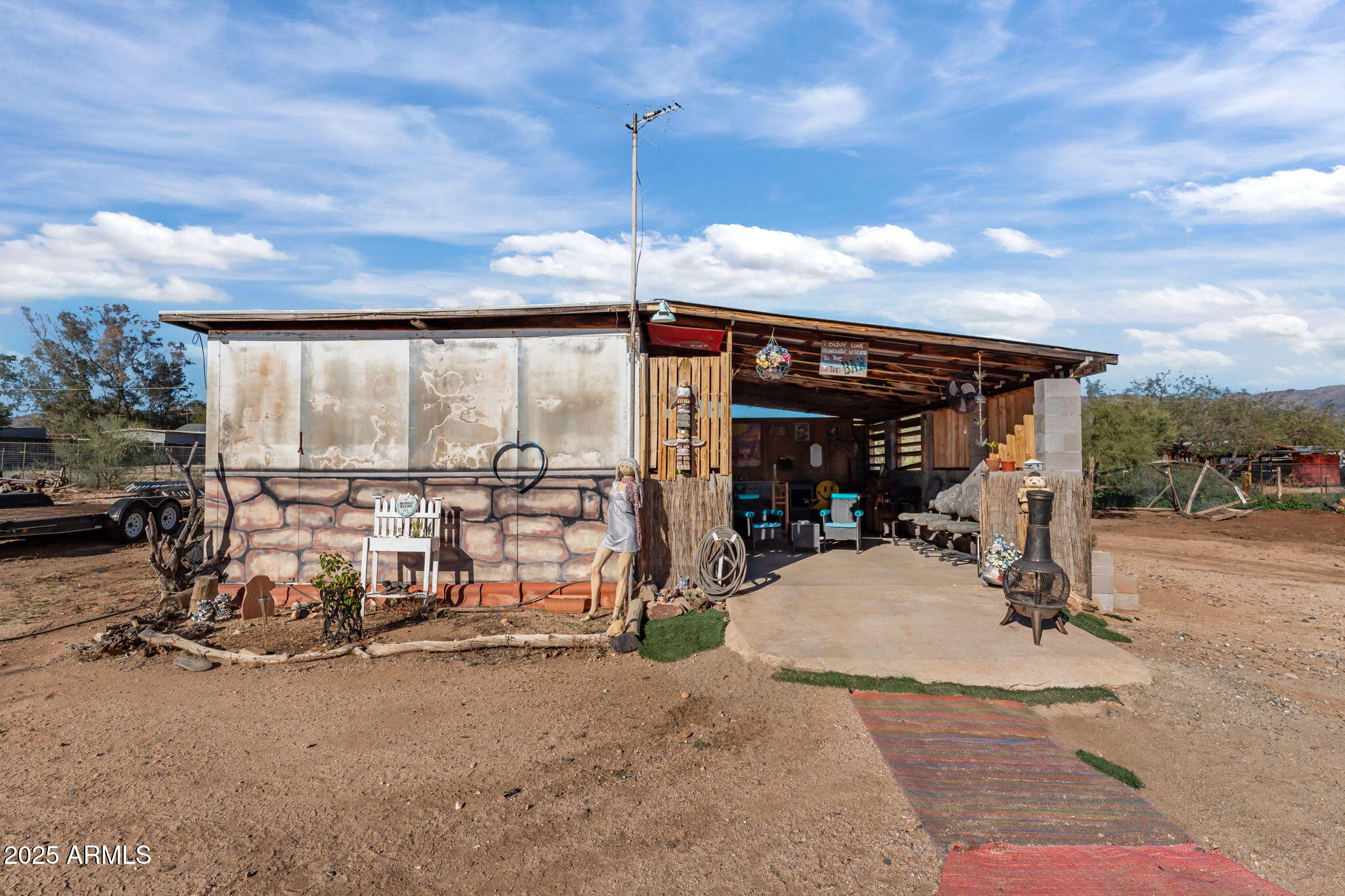 22570 Pacific Street, Unit 7 Congress, AZ 85332 - Photo 4 of 7 a view of a patio with table and chairs