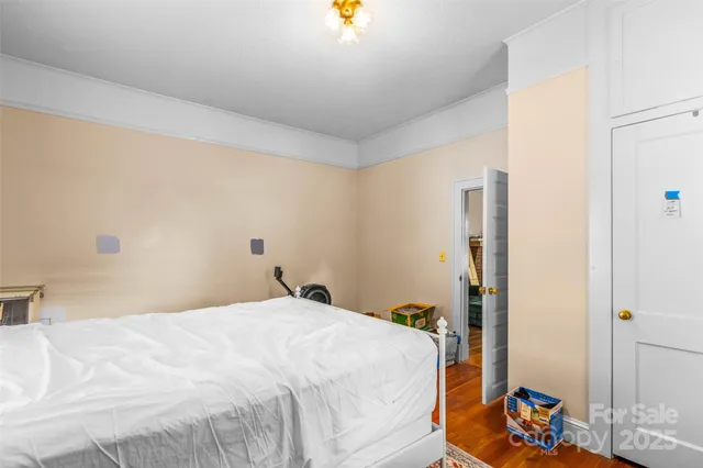 a bedroom with a bed and a chandelier