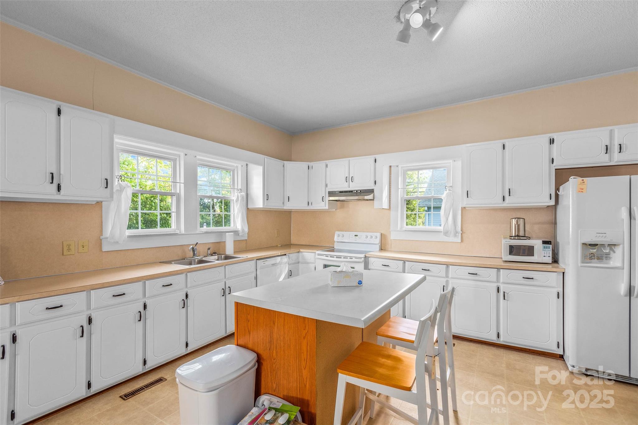 304 South Walnut Street Kannapolis, NC 28081 - Photo 16 of 32 a kitchen with a sink a window and cabinets