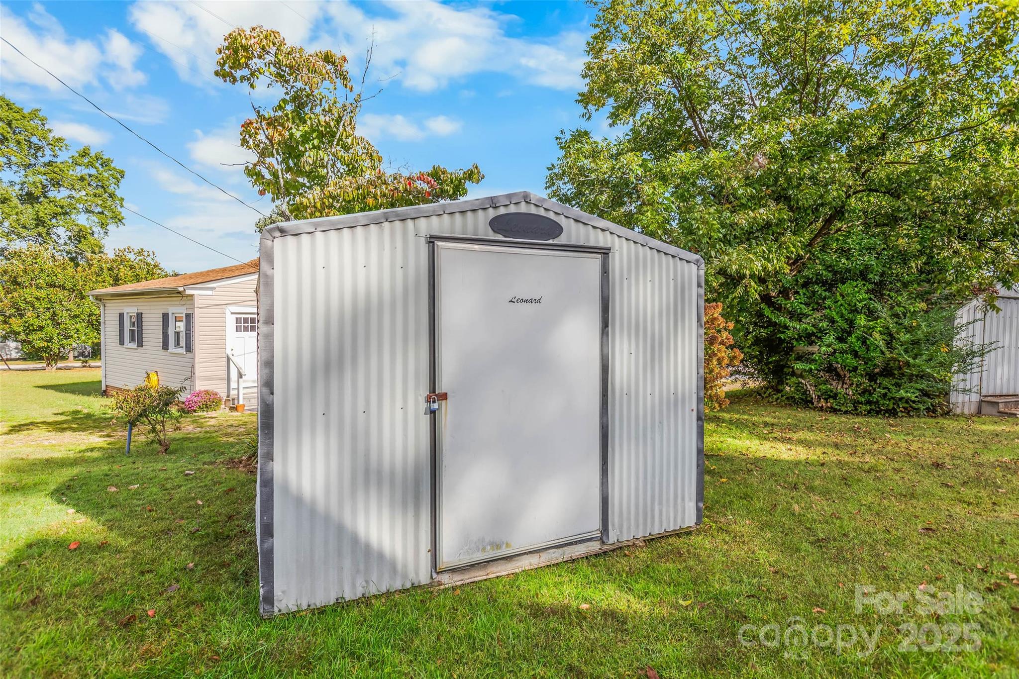 304 South Walnut Street Kannapolis, NC 28081 - Photo 29 of 32 a backyard of a house with plants and large tree