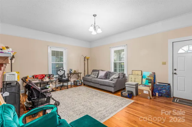 a living room with furniture a rug and a window