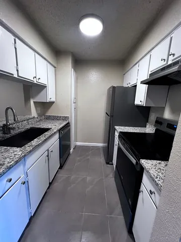 a kitchen with a sink and a refrigerator
