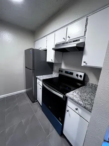 a kitchen with a stove and a refrigerator