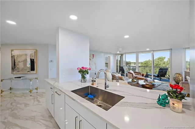 a view of a dining room with furniture large windows and wooden floor
